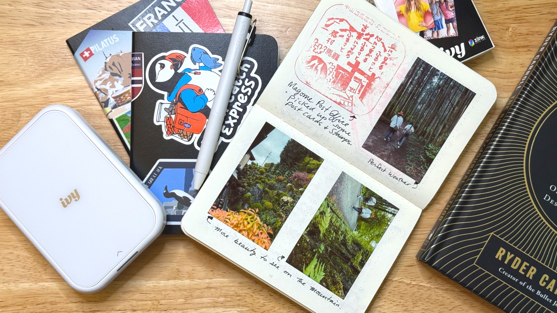 Smaller Bullet Journal travel journals with stickers from the locations I took them.