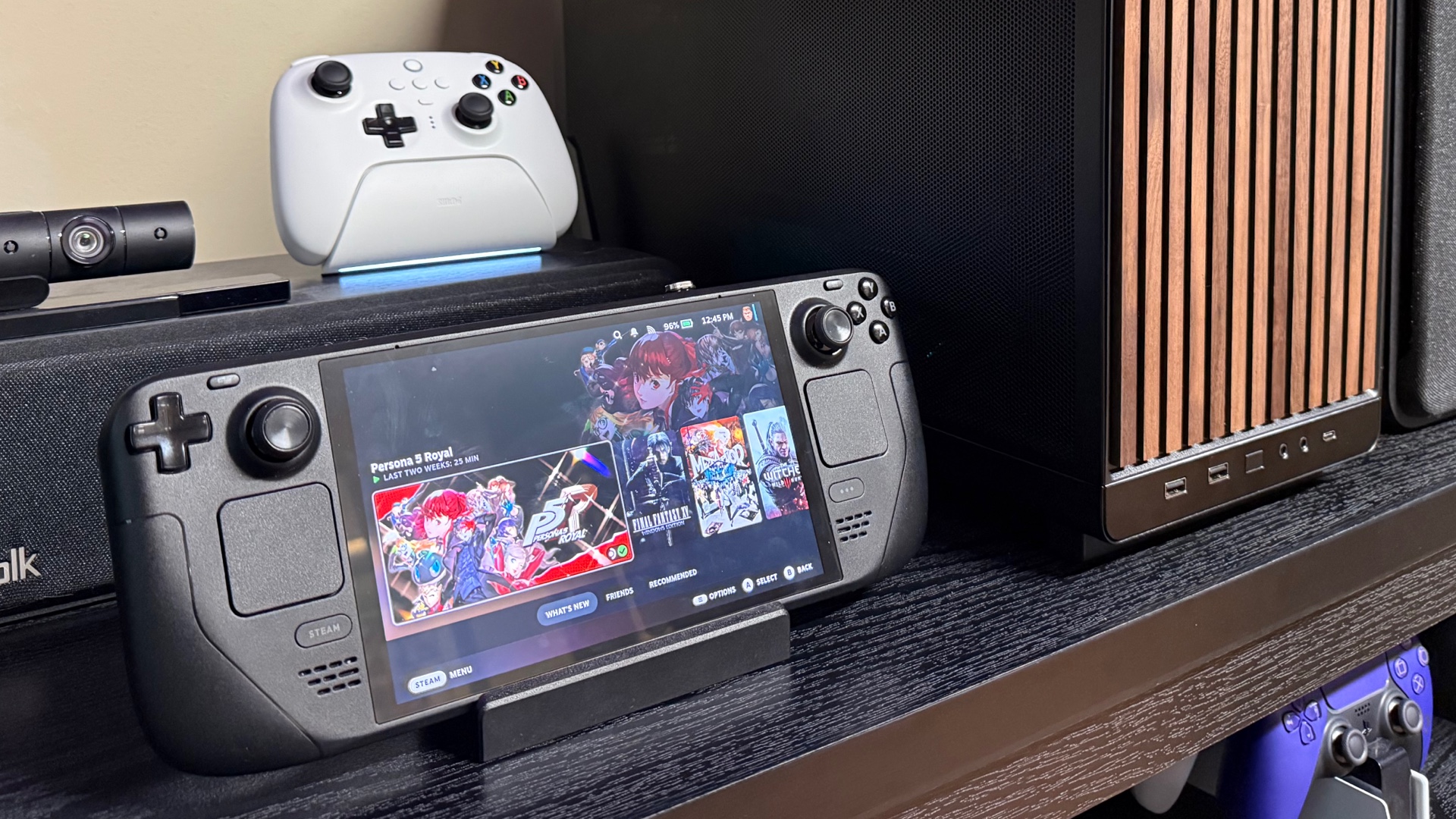 Photo of the Steam Deck next to the PC build