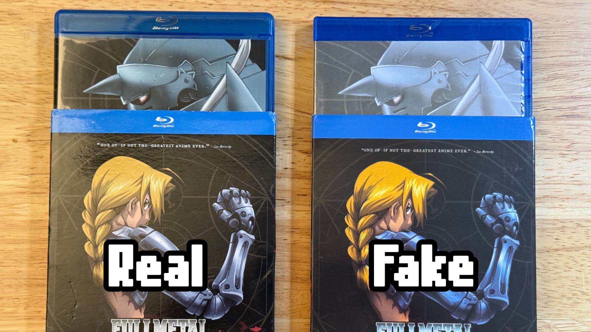 Fullmetal Alchemist: 2 copies showing the outside. One is real and one is fake.