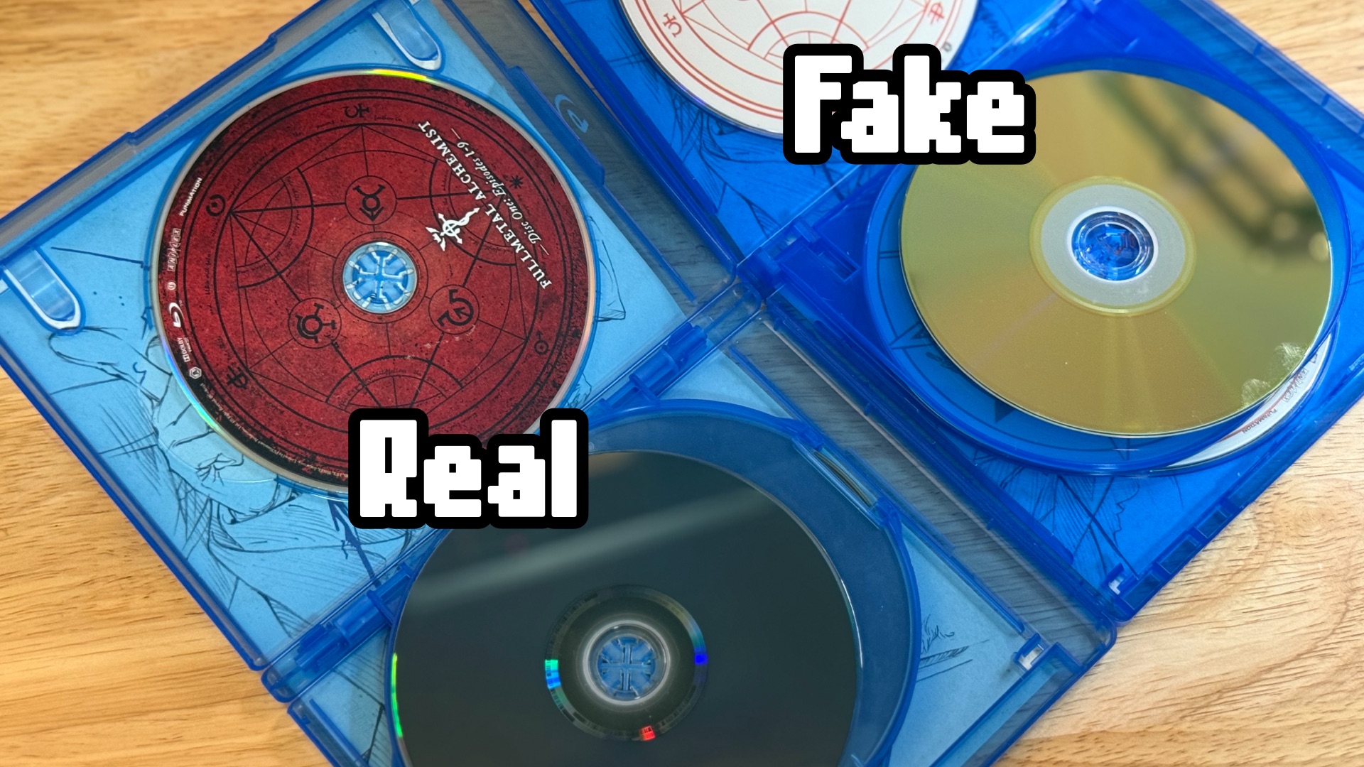 Fullmetal Alchemist: 2 copies showing the discs. One is real and one is fake.